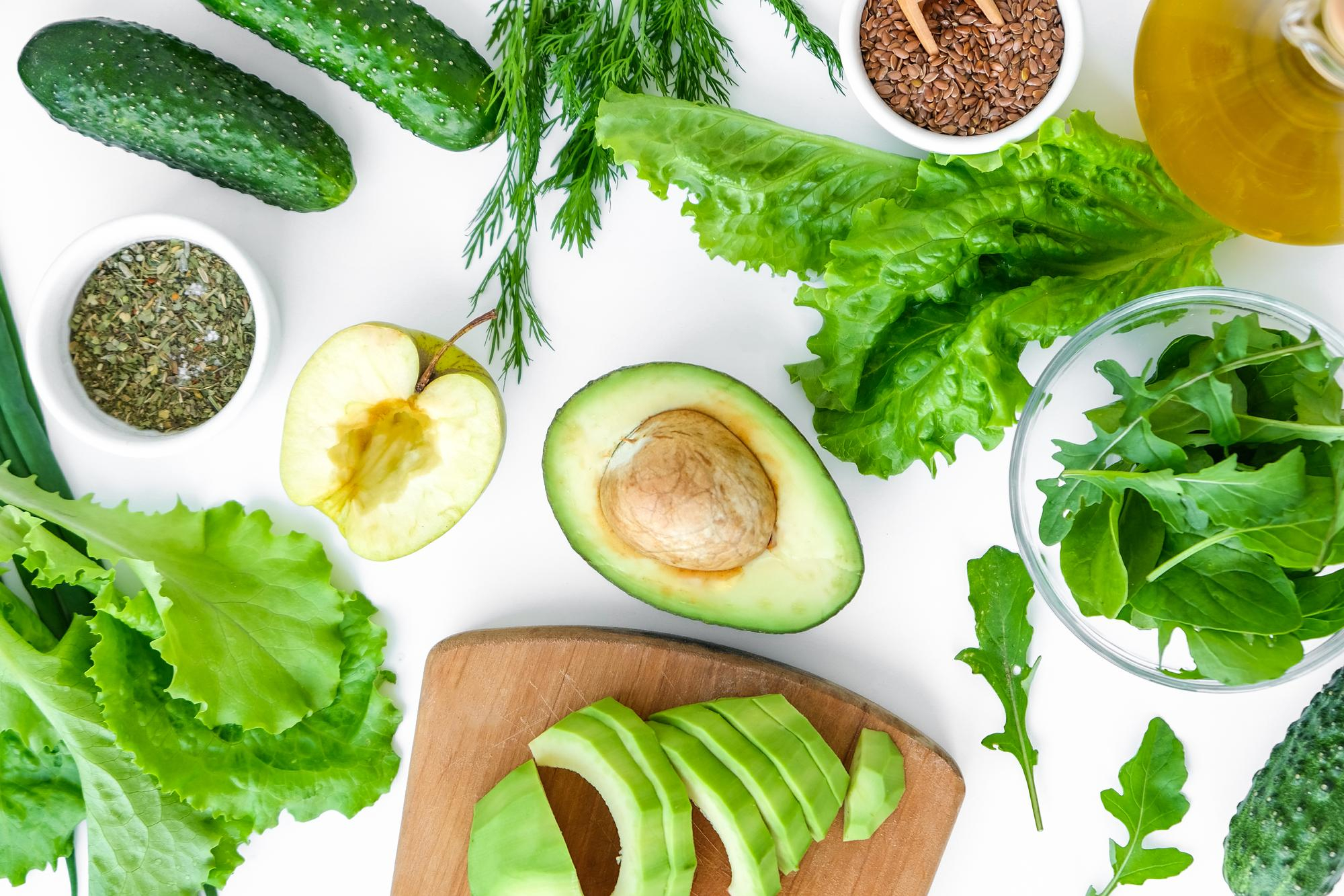 Home cooks learning with fresh ingredients in a bright teaching kitchen